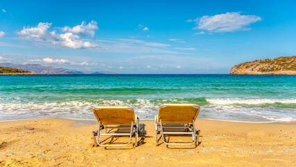 Fototapeta na wymiar Two sunbeds on tropical beach. Summer vacation concept.