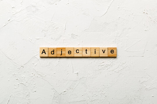 adjective word written on wood block. adjective text on cement table for your desing, concept