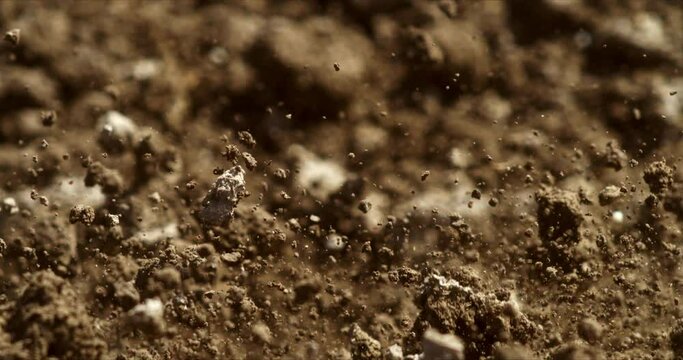Super slow motion macro of land soil is moving while agricola machinery tractor with disk plow harrows cultivates field for sowing in ecological rural farmland agricultural plantation at 1000 fps.