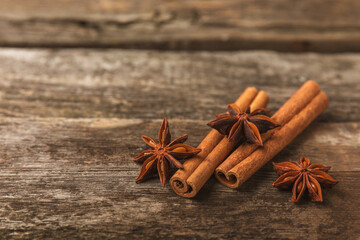 Ceylon cinnamon sticks and anise on a textured wooden background.Cinnamon roll and star anise....