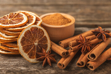 Ceylon cinnamon sticks and anise on a textured wooden background.Cinnamon roll and star anise. Spicy spice for baking, desserts and drinks. Fragrant ground cinnamon.Place for text. copy space. - obrazy, fototapety, plakaty