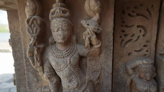 Closup of Indian Ancient Hindu Temple Sculptures on wall, a historic temple made with stone carving and art sculptures in India