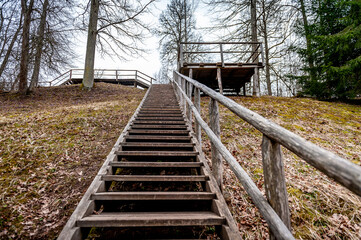 Wooden staircase leading to the top of the hill. Vilce Nature Park, Latvia.