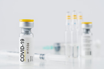 Coronavirus vaccine vial glass with a syringe on white background. Covid-19 medicine vaccination concept. World pandemic concept.