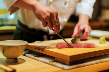 Obraz premium Poster with sushi chef preparing sashimi, traditional Japanese restaurant, fresh and delicious traditional cuisine