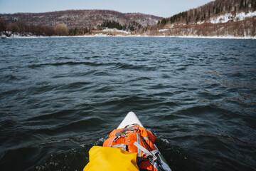 SUP board floats on the river against the background of mountains, rafting on a spring river in...