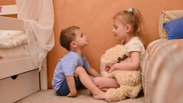A boy kisses a girl on the cheek as a sign of reconciliation and love. slow motion