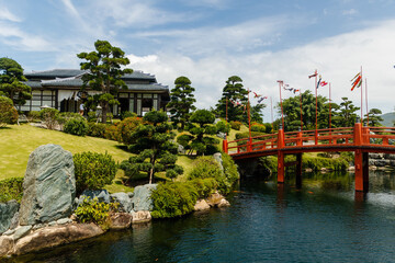Beautiful Japanese garden with red bridge and gazebo