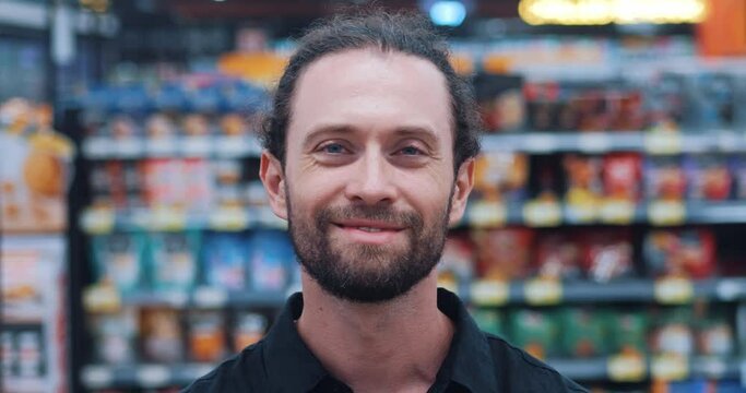 Happy face man in supermarket look at camera smile grocery department. beautiful fresh produce retail shop worker food choosing goods. Customer is about to make a weekly purchase in grocery department