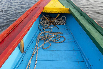 Anchor on a boat painted with the colors of the national flag on a waterway in Saloum, Senegal