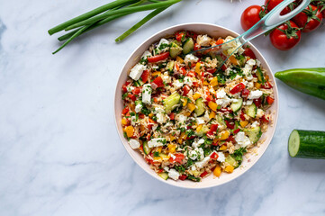 Healthy food background with a delicious rice salad with colorful chopped vegetables