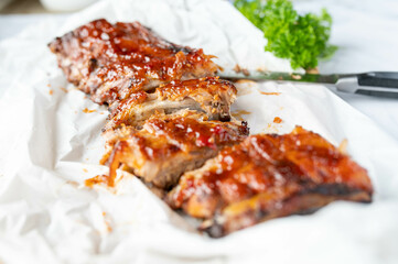 Fresh barbecue honey glazed pork ribs or spareribs on light background