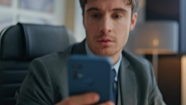Closeup man fingers taking smartphone from office desk. Mad businessman reacting