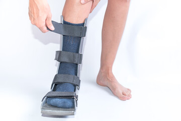 Woman Putting on a Walking Boot for Foot Sprain or Fracture