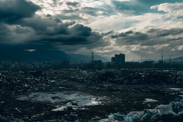 Polluted landscape with garbage dumpsite overshadowing city skyline. Environment ecology problems