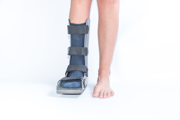 Woman with Sprained or Fractured Foot Wearing a Walking Boot, White Background