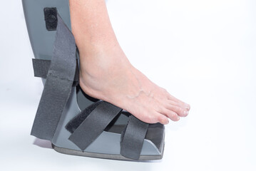 close up, Woman Putting on a Walking Boot for Foot Sprain or Fracture