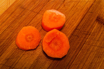 Chopped carrots on a wooden chopping board