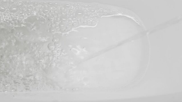 A stream of urine in a white toilet
