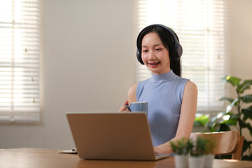 Successful businesswoman has fun selling online and delivering packages in her home office Woman checking orders on notebook and laptop, SME business concept
