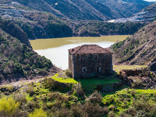 Aerial image of a historical abandoned fortified house build on the top of a rocky hill over 200...