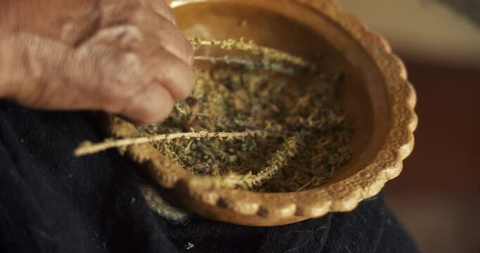 Herbs Separation in a Wooden Bowl by Hands