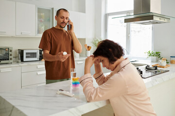 Caring man calling family doctor asking what medicine to give his sick wife