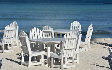 White Wooden Tables and Chairs Along the Beach