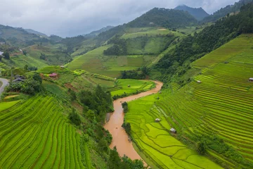Fototapete Mu Cang Chai Aerial top view of paddy rice terraces, green agricultural fields in countryside or rural area of Mu Cang Chai, Yen Bai, mountain hills valley at sunset in Asia, Vietnam. Nature landscape background.
