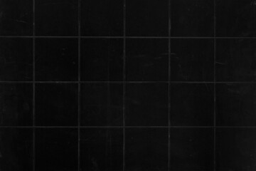 Old black ceramic tiles texture. Grunge background