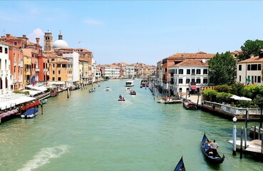 View of the Grand Canal from the bridge in Venice on a sunny summer day.