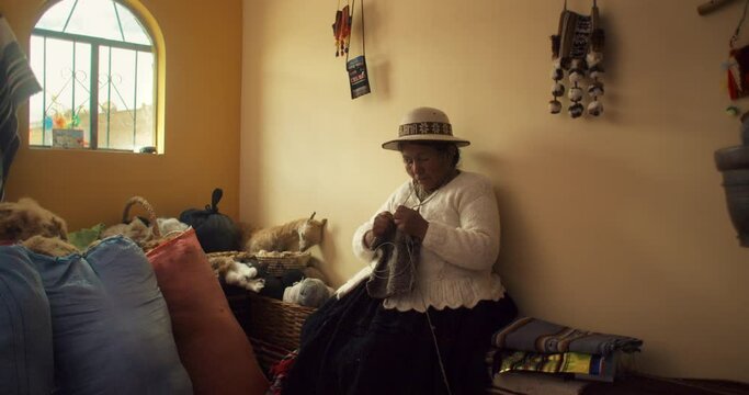 A Bolivian woman Knitting Wool to make traditional clothes