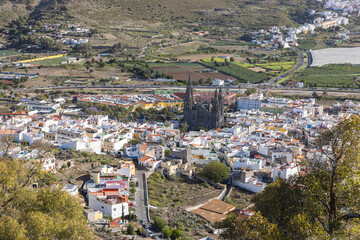 Looking down from Montaña Arucas to the city of Arucas with the distinct dark church (Parroquia)...