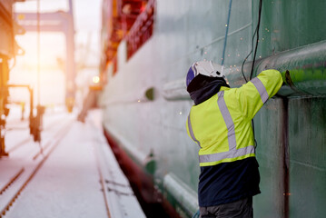 Certified Welder Technician Wearing The Protective Clothes And Equipment While Working With A Welding Machine To Repair The Crack On The Hull Of The Merchant Vessel.