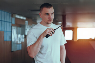 Seafarer Seaman Deck Officer In Charge Of Navigational Watch And Radiocommunication In The Wheelhouse Of Merchant Offshore Vessel Ship © I am from Mykolayiv