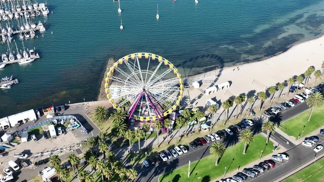 High wide drone footage of Ferris wheel near beach