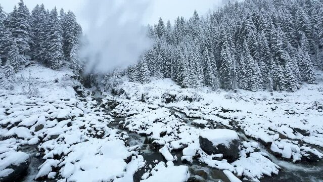 First snow snowing white out blizzard fog October November fall autumn river waterfall boulder rocks Stubai Stubaital glacier ski resort Tyrol Innsbruck Austrian Europe Alps mountain pan left