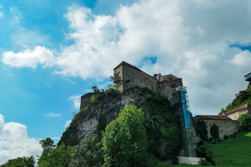 Naklejka premium Panoramic view of medieval castle Rabenstein on a hill in Frohnleiten, Murtal, Styria (Steiermark), Austria. Travel destination sunny day in summer. Surrounded by idyllic forest in foothills of Alps