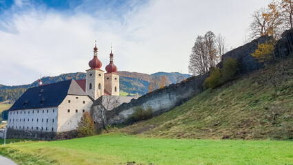 Exterior view of Benedictine monastery Saint Lambrecht Abbey in nature reserve Grebenzen, Styria, Austria. Religious landmark with rich and unique architect features. Travel destination. Sightseeing - obrazy, fototapety, plakaty