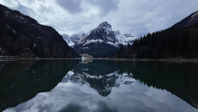 Crystal clear Lake Obersee in which a high snow-capped mountain is reflected. Amazing natural scenery of mountain apl landscape in switzerland