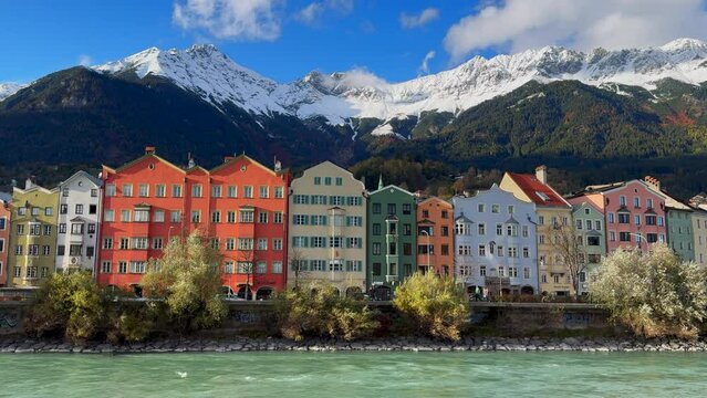 October November autumn fall Innsbruck Austria colorful pastel buildings capital Tyrol Tyrolean Alps mountain backdrop  the bridge over the Inn River Innbr&uuml;cke clear blue sky clouds static shot