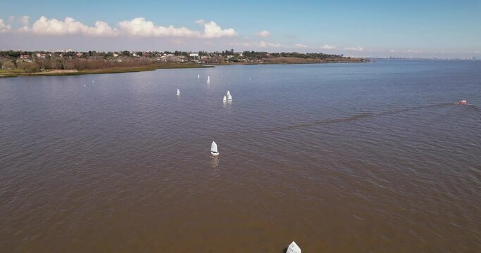 Optimist sailboats dotting the river - aerial view