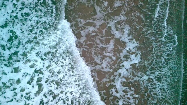 Static aerial shot of the sea as the waves crash together.

Produced in 4K 60fps at Portrush West Stran Beach, Northern Ireland. Filmed with Rec709 color space.