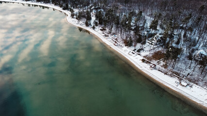 Peaceful Lake Michigan shoreline in winter with snow on beach