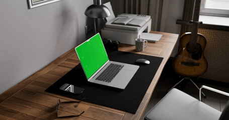 Laptop place on room table, Green screen display, Close up monitor of notebook with mock up - 777626962
