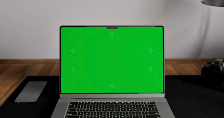 Laptop place on room table, Green screen display, Close up monitor of notebook with mock up - 777627127