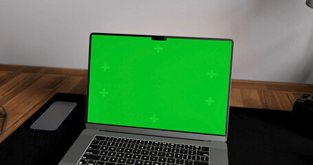 Laptop place on room table, Green screen display, Close up monitor of notebook with mock up - 777627582