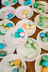 Fototapeta na wymiar Overhead view of plates with colored Easter eggs
