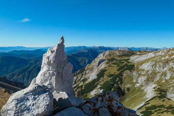 Selective focus on rock formation with scenic view mountain peaks of wild Hochschwab massif,...