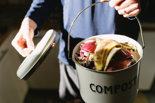 open compost bucket full of fruit and vegetable food scraps